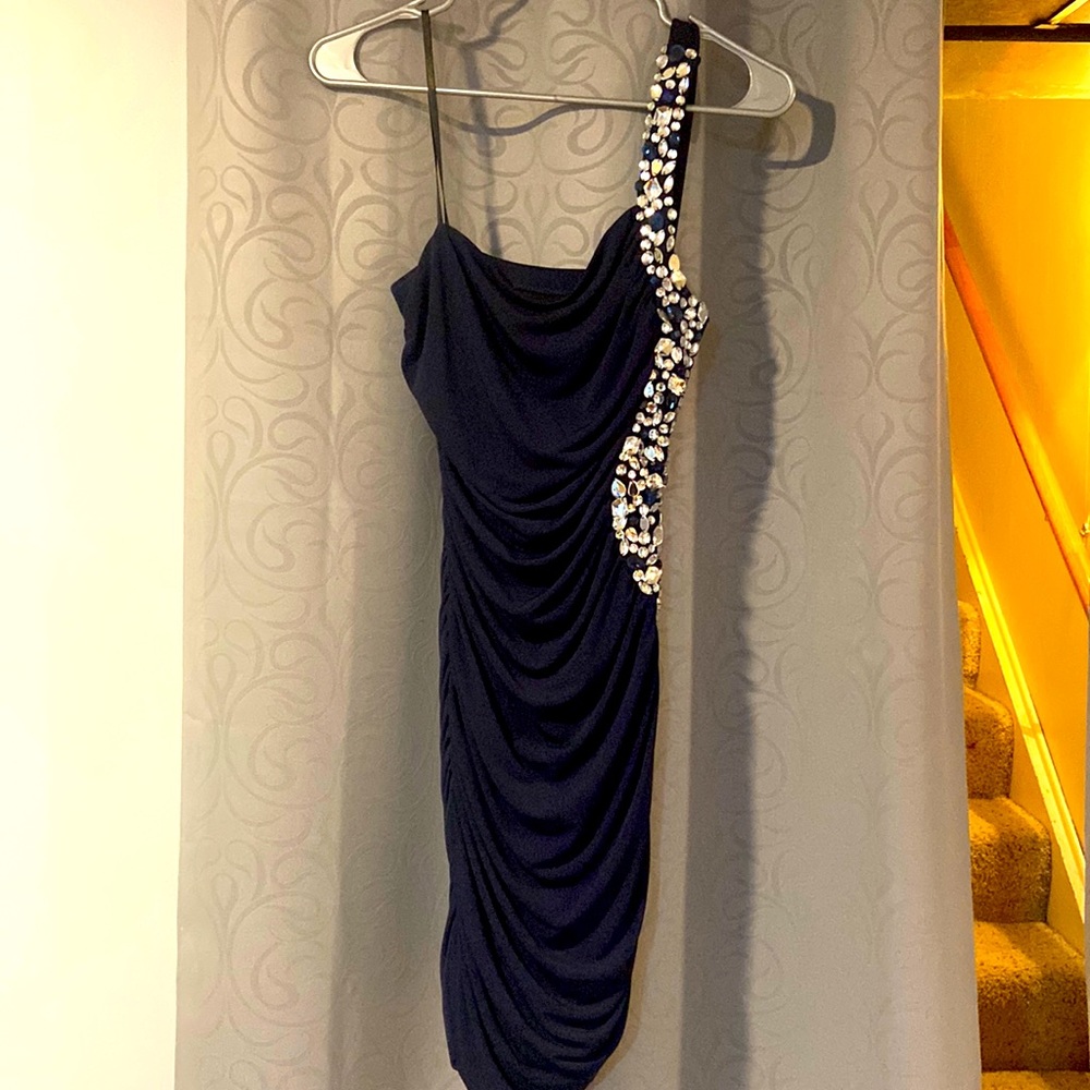 navy blue knee length dress with jewels on the side and strap